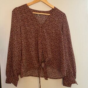 Dress shirt with buttons down to a tie at the bottom. Size small.